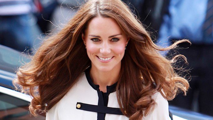 Kate Middleton wearing white and navy dress with long hair