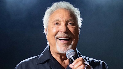 Sir Tom Jones, 82, pictured with walking stick following health scare