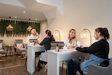 A nail salon with two people doing their nails