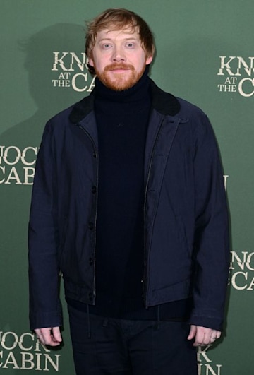 Rupert Grint in a coat on the red carpet