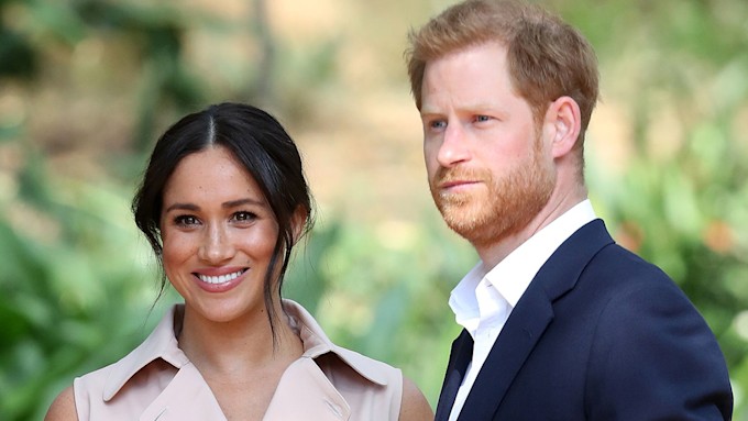 Prince Harry and Duchess Meghan pose for cameras