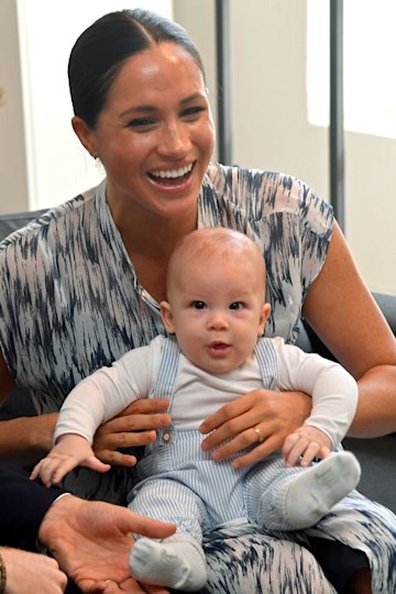 Meghan Markle smiles as she holds her baby son Archie