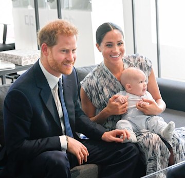 Harry and Meghan smiling with baby Archie