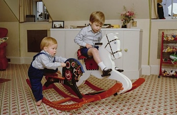 Princes William and Harry on rocking horses