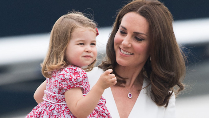 Princess Kate holds Princess Charlotte in her arms