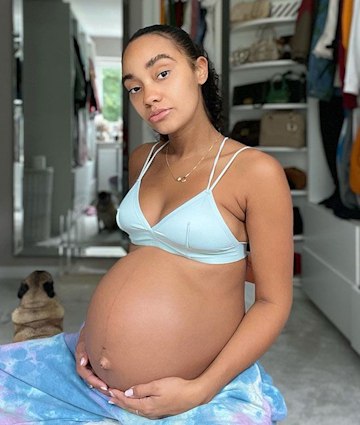 Leigh Anne Pinnock cradles her bare baby bump