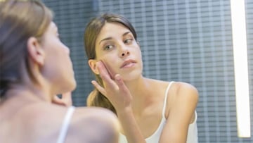 woman-moisturising-face