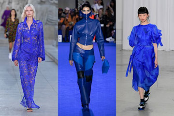 Three models wearing blue on the runway 