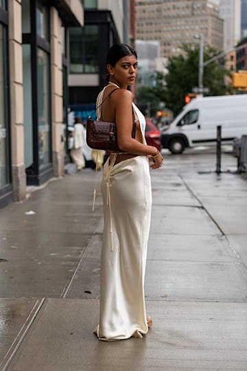 Woman Wears Backless Dress With Sleek Shoulder Bag