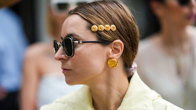 Woman wearing gold circular earrings 