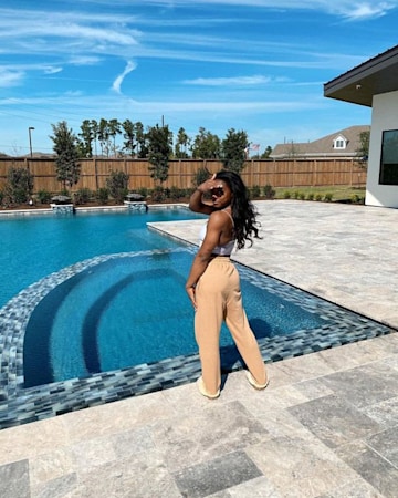 simone-biles on her large outdoor pool