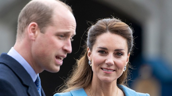 prince william talking and kate middleton looking at him 