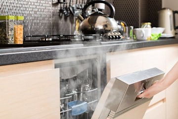 dishwasher being opened with steam coming out
