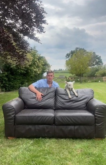 will young by sofa outside on farm