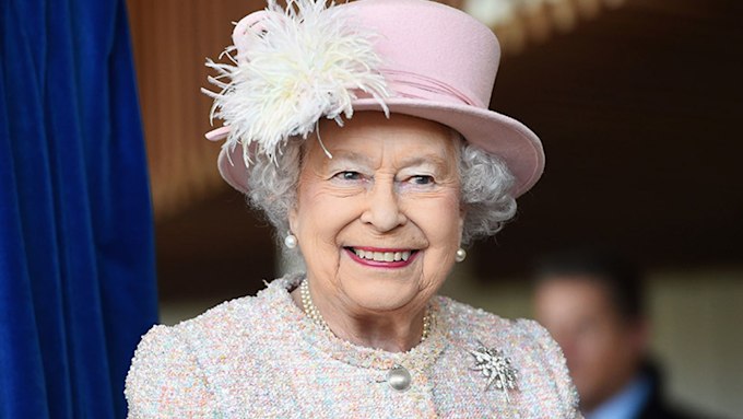 Queen Elizabeth smiling in pink outfit