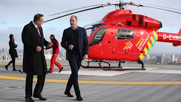 Prince William in front of helicopter