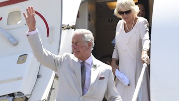 prince charles and camilla leaving an airplane