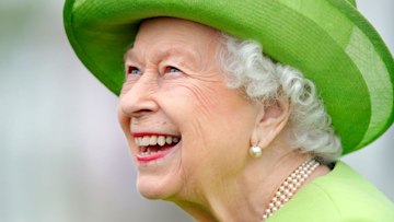 the queen smiling green hat