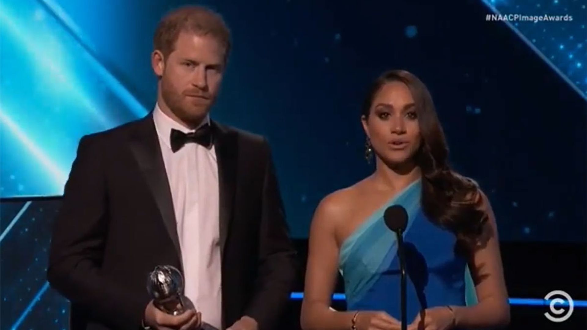 Meghan Markle stuns in blue gown as she and Prince Harry's accept award