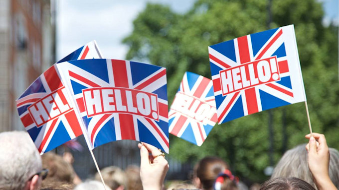 Royal fans seen waving HELLO! flags and cheering on the Queen amid ...