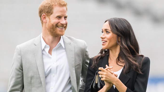 meghan markle and prince harry smiling as they look at each other