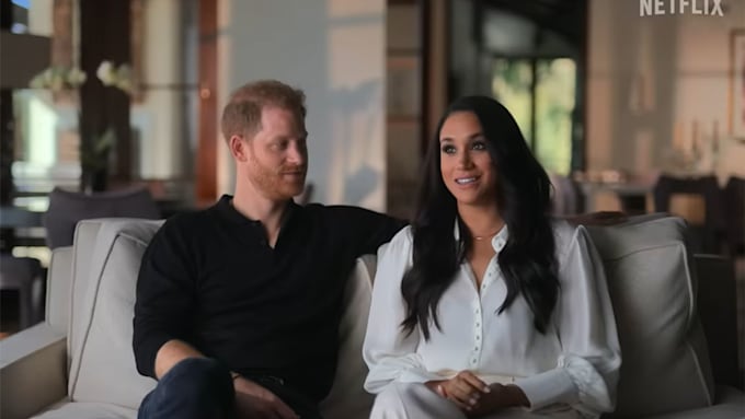 Prince Harry looking at Meghan Markle as they sit inside their Montecito home during their docuseris