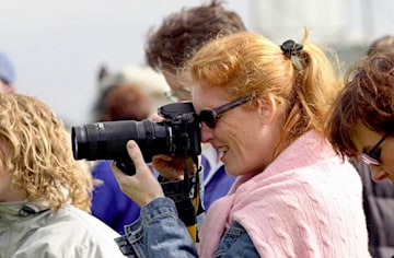 sarah ferguson wearing a pink jumper taking a photo