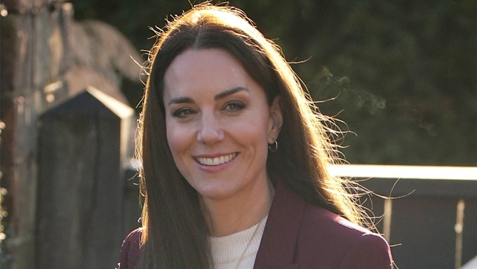 Kate Middleton wearing maroon pantsuit at Hampton Court Palace.