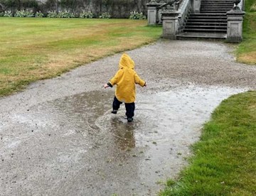 August Brooksbank splashing in puddles