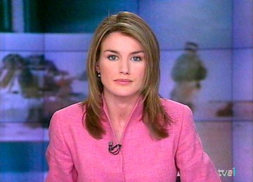 queen letizia of spain pictured when she was a newsreader sitting behing a news desk