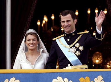 queen letizia and king felipe smile and wave to the crowds on their wedding day