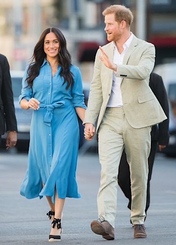 Prince Harry and Meghan Markle smile and hold hands in South Africa