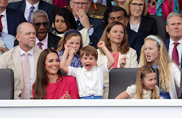 Prince Louis with his hands in the air alongside mum Kate and sister Charlotte during the Platinum Pageant 
