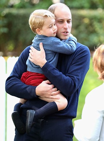 Prince William hugging Prince George at a children's party for Military families during the Royal Tour of Canada on September 29, 2016