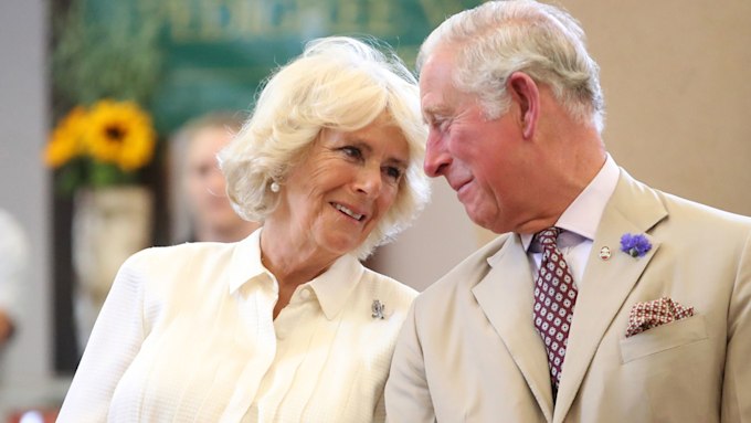 king charles and queen camilla smile as they lean heads together