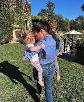 meghan markle carrying archie and lilibet in montecito garden