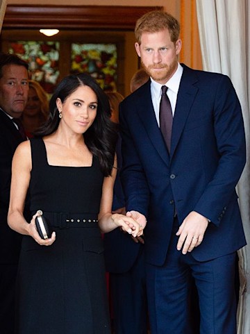 Meghan Markle looking gorgeous in a black dress whilst Harry wears dark blue suit during royal tour