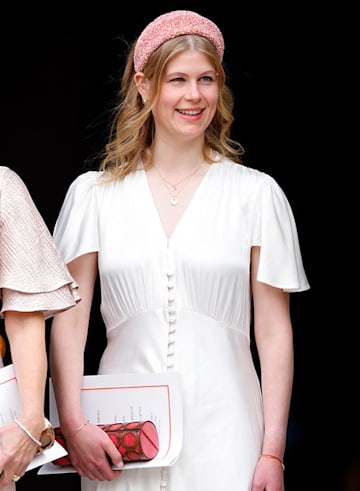 lady louise windsor smiles in solo photo wearing white dress and statement pink headband
