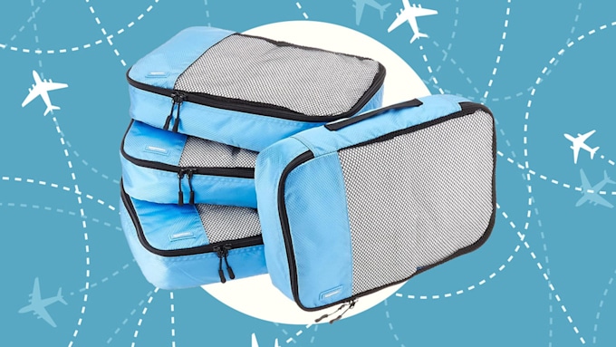 travel packing cubes on plane background