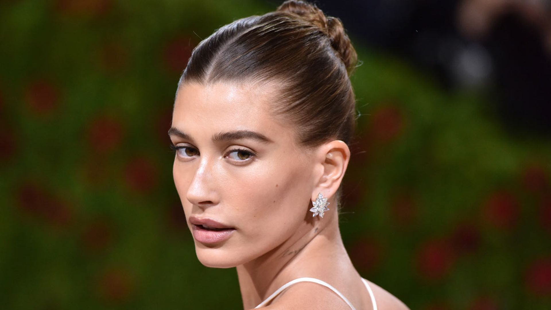 Hailey Bieber is a summer goddess as she plunges into pool in tiny bikini – watch